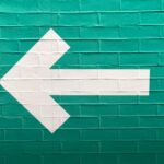 selective focus photography of white arrow signage